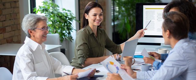 Team meeting with laptop — Hobart business consultancy and advisory services